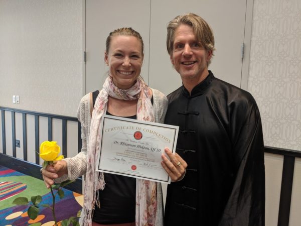 Student Dr. Rhiannon Hutton receives level I Qigong Awareness Certified Qigong Instructor Certificate at closing of Live Workshop