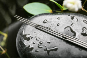 Acupuncture needles on a wet stone