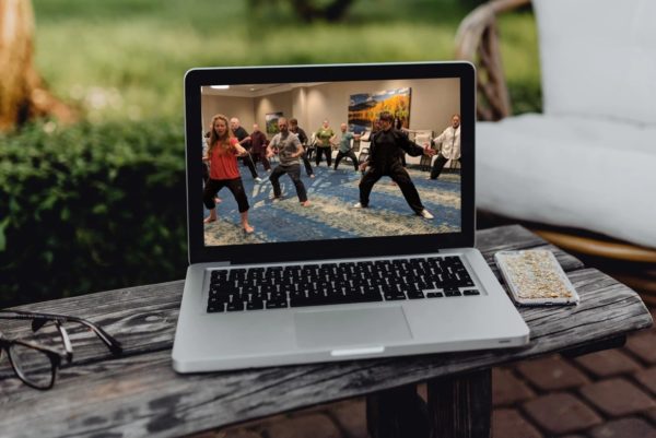This photograph shows a laptop computer with a Qigong Awareness Class with students practicing Qigong with Instructor David J. Coon