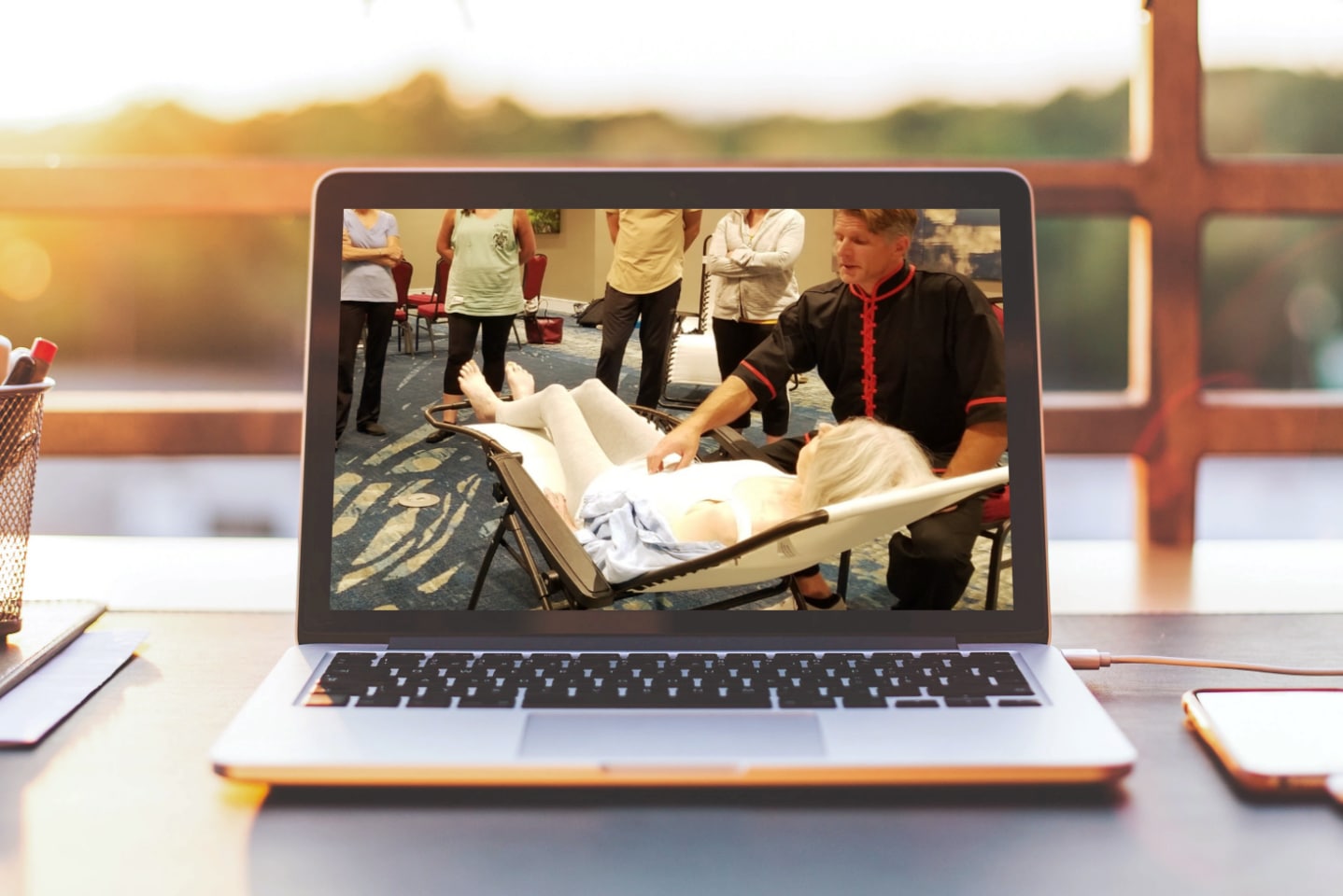 In this photo a laptop computer with a picture of instructor David J. Coon giving a Medical Qigong Treatment to a Workshop Participant