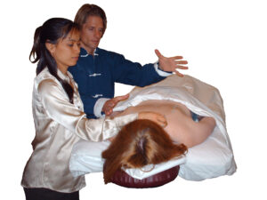 David J. Coon, Medical Qigong Master, and Tanya Mei-Tai Coon, Acupnuncturist giving a treatment