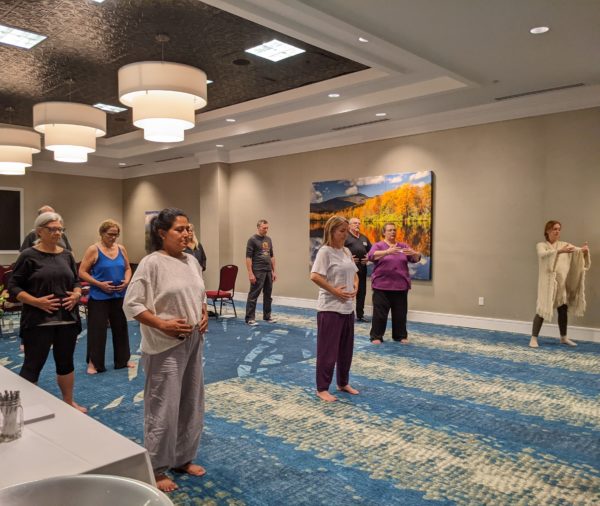 A group practicing qigong movement