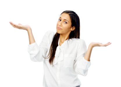 Woman in white shirt shrugging with outstretched hands