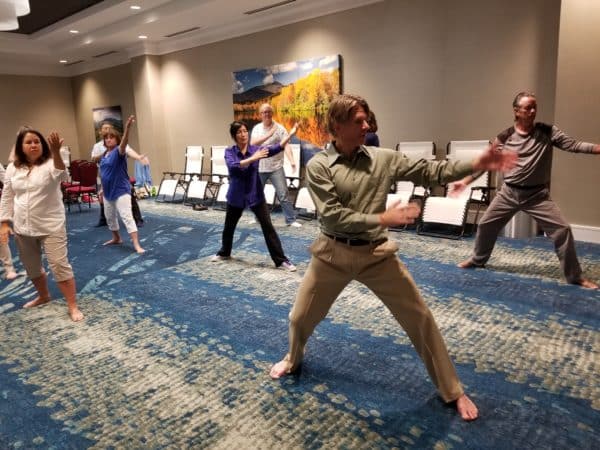 David Coon leading a group of students in Qigong movement