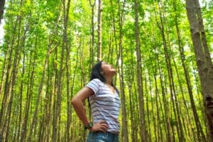 asian girl in the forest taking a purifying breath