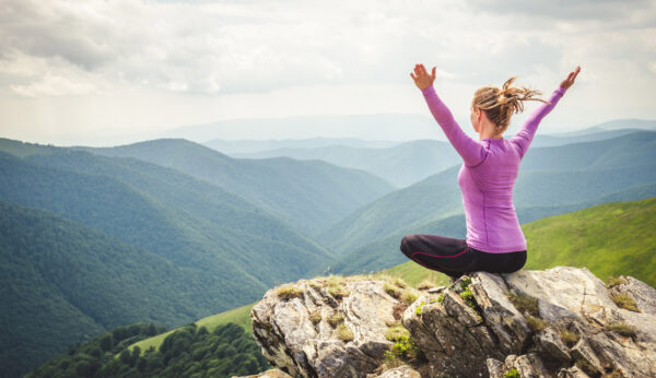 woman practicing qigong on a mountain