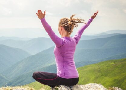 woman practicing qigong on a mountain
