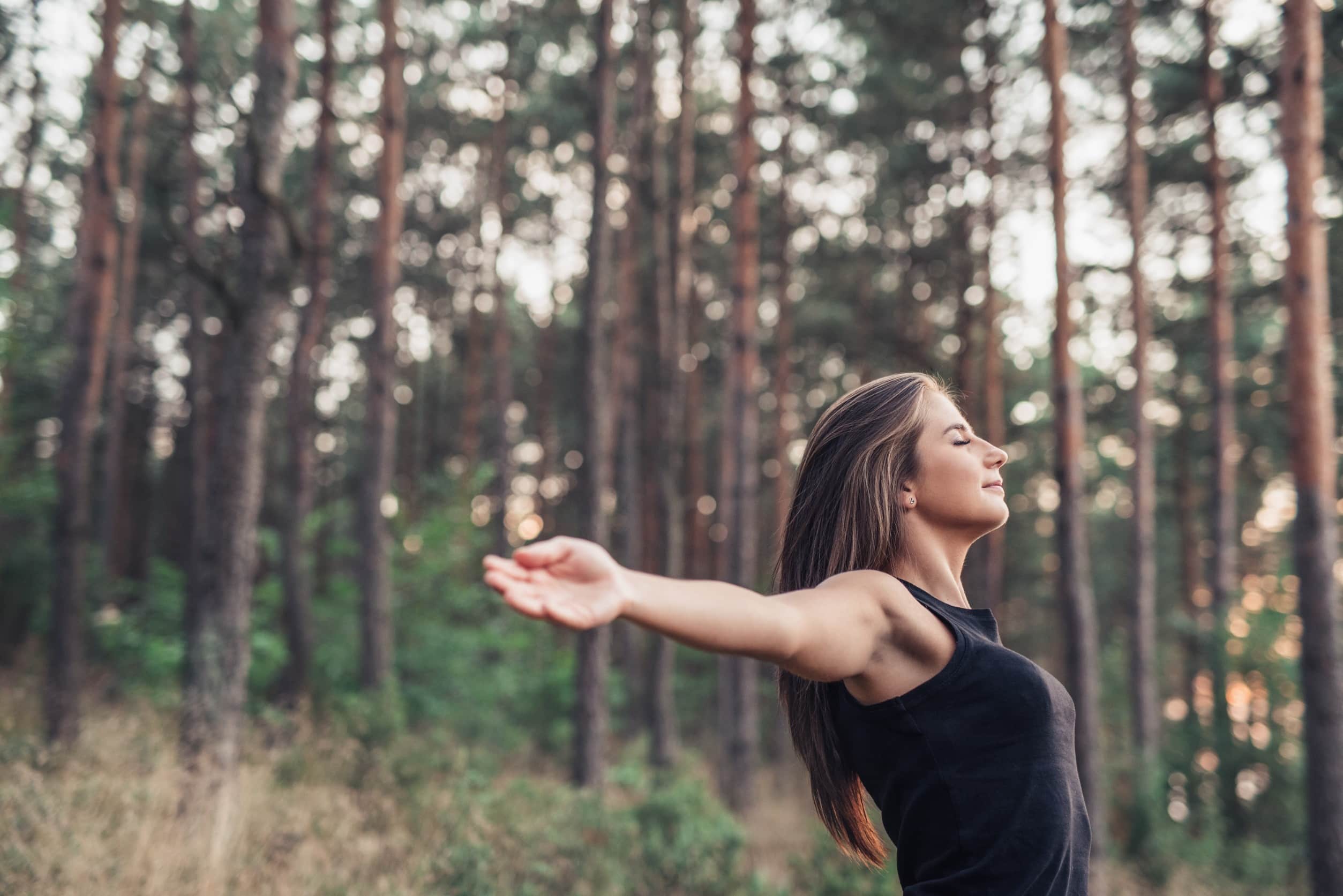 woman practicing qigong on a mountain